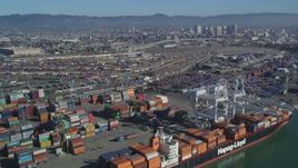 5K aerial stock footage Flying by cargo cranes, shipping containers, cargo ships, Port of Oakland, Oakland, California Aerial Stock Footage | DCSF05_078
