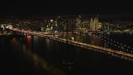 5K aerial stock footage Flying by Bay Bridge with the downtown skyline behind it, San Francisco, California, night Aerial Stock Footage | DCSF06_014