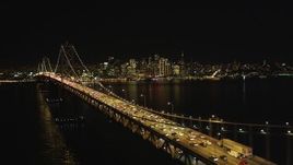 5K aerial stock footage Flying by heavy Bay Bridge traffic, Downtown San Francisco skyline in background, California, night Aerial Stock Footage | DCSF06_033