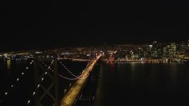 5K aerial stock footage Reverse fly over Bay Bridge with skyline in background, Downtown San Francisco, California, night Aerial Stock Footage | DCSF06_086