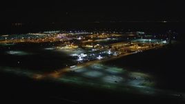 5K aerial stock footage Reverse view of Oakland International Airport, Oakland, California, night Aerial Stock Footage | DCSF06_105