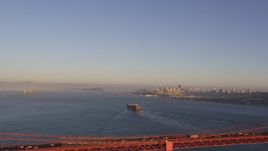 5K aerial stock footage Cargo ship sailing the bay, Golden Gate Bridge, skyline in the distance, San Francisco, California, sunset Aerial Stock Footage | DCSF07_038