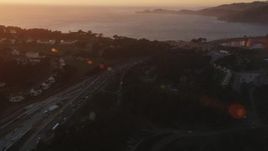 5K aerial stock footage Pan across Highway 101 in Presidio, reveal Golden Gate Bridge, San Francisco, California, sunset Aerial Stock Footage | DCSF07_051