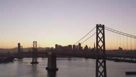 5K Aerial Video Flyby Bay Bridge with a view of Downtown San Francisco, California, twilight Aerial Stock Footage | DCSF07_070