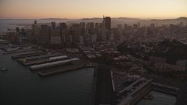 5K Aerial Video Fly away from piers, Coit Tower, and Downtown San Francisco, California, twilight Aerial Stock Footage | DCSF07_081