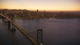 5K Aerial Video Reverse view of heavy Bay Bridge traffic and Downtown San Francisco, California, twilight Aerial Stock Footage | DCSF07_100