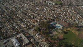 5K Aerial Video Reverse view of residential neighborhoods and Washington Manor Park, San Leandro, California Aerial Stock Footage | DCSF08_002