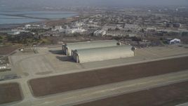 5K Aerial Video Tilt from a parked jet to reveal and approach Hangar Two and Three, Moffett Field, Mountain View, California Aerial Stock Footage | DCSF08_021