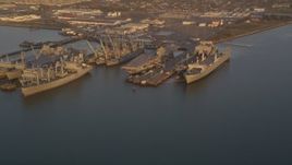 5K Aerial Video Flyby base and reveal USS Hornet and ships at Naval Air Station Alameda, California, sunset Aerial Stock Footage | DCSF10_001