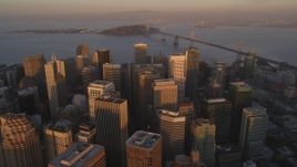 5K Aerial Video Tilt to reveal and fly over skyscrapers in Downtown San Francisco, California, and approach the Bay Bridge, twilight Aerial Stock Footage | DCSF10_006