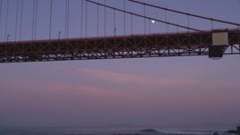 5K Aerial Video Fly low and look up at the moon and Golden Gate Bridge, San Francisco, California, twilight Aerial Stock Footage | DCSF10_033