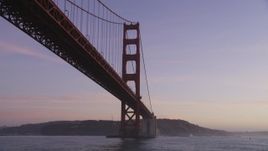 5K Aerial Video Fly low and tilt up to a tower of the Golden Gate Bridge, San Francisco, California, twilight Aerial Stock Footage | DCSF10_035