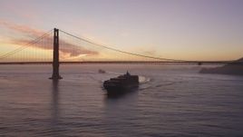 5K Aerial Video Track cargo ship sailing by the Golden Gate Bridge, San Francisco, California, twilight Aerial Stock Footage | DCSF10_041