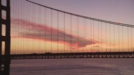 5K Aerial Video Flying by one of the Golden Gate Bridge towers with traffic passing by, San Francisco, California, twilight Aerial Stock Footage | DCSF10_047