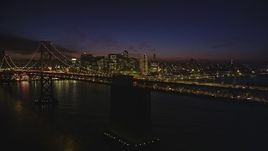 5K Aerial Video Flying by the Bay Bridge with the skyline in background, Downtown San Francisco, California, night Aerial Stock Footage | DCSF10_079