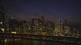 5K Aerial Video of Downtown San Francisco skyline seen while passing by the Bay Bridge, California, night Aerial Stock Footage | DCSF10_083
