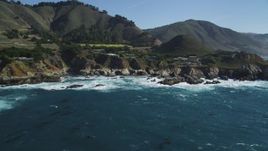 5K Aerial Video Flyby waves crashing into rocks below coastal homes, Carmel, California Aerial Stock Footage | DCSF11_019