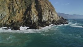 5K Aerial Video Fly low over waves slamming into coastal cliffs, Big Sur, California Aerial Stock Footage | DCSF11_031
