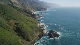 5K Aerial Video Fly over coastal cliffs and tilt to waves crashing into rocks, Big Sur, California Aerial Stock Footage | DCSF11_036