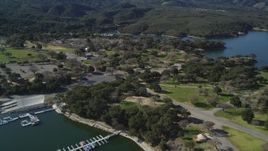5K aerial stock footage of approaching an RV Park with boats at the docks, Lake Cachuma, California Aerial Stock Footage | DFKSF01_058