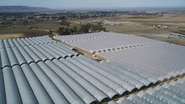 5K aerial stock footage of flying over greenhouses at a farm in Santa Maria, California Aerial Stock Footage | DFKSF02_003