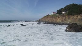 5K aerial stock footage fly over crashing waves toward lighthouse on cliffs, San Luis Obispo, California Aerial Stock Footage | DFKSF02_054