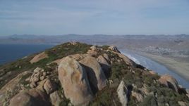 5K aerial stock footage tilt from bay, reveal Morro Rock, Morro Strand State Beach, Morro Bay, California Aerial Stock Footage | DFKSF03_001