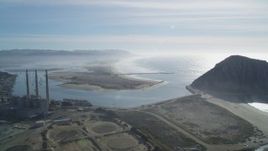 5K aerial stock footage of flying by Dynegy Power Plant, Morro Rock, coast, harbor in Morro Bay, California Aerial Stock Footage | DFKSF03_012