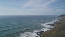 5K aerial stock footage of tilting from green hills to reveal the coastline, Cayucos, California Aerial Stock Footage | DFKSF03_020