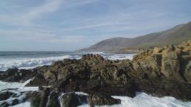 5K aerial stock footage of flying over waves rolling toward coastline, Harmony, California Aerial Stock Footage | DFKSF03_030
