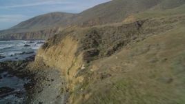 5K aerial stock footage of flying low over rugged coastal cliffs and ocean waves, Cambria, California Aerial Stock Footage | DFKSF03_032