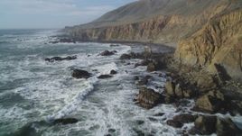 5K aerial stock footage of flying by the rugged coastal cliffs and over waves, Cambria, California Aerial Stock Footage | DFKSF03_033