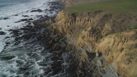 5K aerial stock footage of following the rocky coastline, tilt down to steep coastal cliffs, Cambria, California Aerial Stock Footage | DFKSF03_038