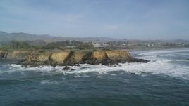 5K aerial stock footage of flying away from jagged coastal cliffs, San Simeon, California Aerial Stock Footage | DFKSF03_049