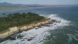 5K aerial stock footage of flying by waves rolling into the coastline, San Simeon, California Aerial Stock Footage | DFKSF03_055