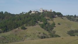 5K aerial stock footage of flying over rocky hillside, revealing iconic Hearst Castle, San Simeon, California Aerial Stock Footage | DFKSF03_061