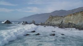 5K aerial stock footage of flying over waves crashing into rock formations, San Simeon, California Aerial Stock Footage | DFKSF03_078