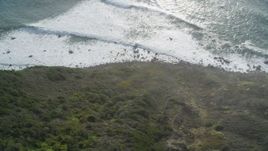 5K aerial stock footage of a bird's eye view of ocean waves rolling toward coastal cliffs, Big Sur, California Aerial Stock Footage | DFKSF03_085