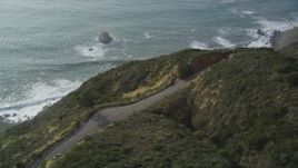 5K aerial stock footage track white convertible on Highway 1, above coastal cliffs, Big Sur, California Aerial Stock Footage | DFKSF03_087