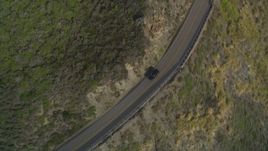5K aerial stock footage of tracking a black SUV on Highway 1, above coastal cliffs, Big Sur, California Aerial Stock Footage | DFKSF03_088