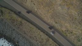 5K aerial stock footage of a bird's eye view of black cars on Highway 1, above coastal cliffs, Big Sur, California Aerial Stock Footage | DFKSF03_090