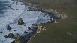 5K aerial stock footage pan from bird's eye view of ocean waves, reveal coastal cliffs, rock formations, Big Sur, California Aerial Stock Footage | DFKSF03_102