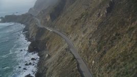 5K aerial stock footage of following Highway 1 coastal road past cliffs, tracking a white car, Big Sur, California Aerial Stock Footage | DFKSF03_112