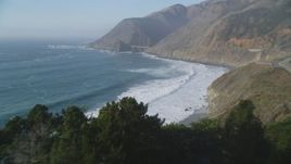 5K aerial stock footage fly over ocean waves, approach small bridge on Highway 1 and coastal cliffs, Big Sur, California Aerial Stock Footage | DFKSF03_114