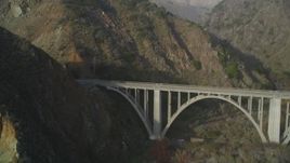 5K aerial stock footage of flying over ocean kelp to reveal small bridge on Highway 1 and cliffs, Big Sur, California Aerial Stock Footage | DFKSF03_115