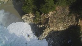 5K aerial stock footage of approaching McWay Falls, tilt to bird's eye of waves crashing, Big Sur, California Aerial Stock Footage | DFKSF03_117