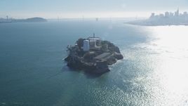 5K aerial stock footage of fly away from iconic Alcatraz, reveal city skyline and Bay Bridge, San Francisco, California Aerial Stock Footage | DFKSF05_027