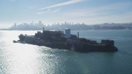 5K aerial stock footage of flying by the historic landmark Alcatraz with views of city skyline, San Francisco, California Aerial Stock Footage | DFKSF05_029