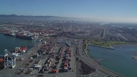 5K aerial stock footage of panning across shipping containers and flying over the Port of Oakland, California Aerial Stock Footage | DFKSF05_094