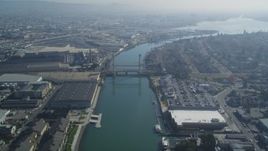 5K aerial stock footage follow Oakland Estuary, approach bridges and waterfront factories, Oakland, California Aerial Stock Footage | DFKSF05_100